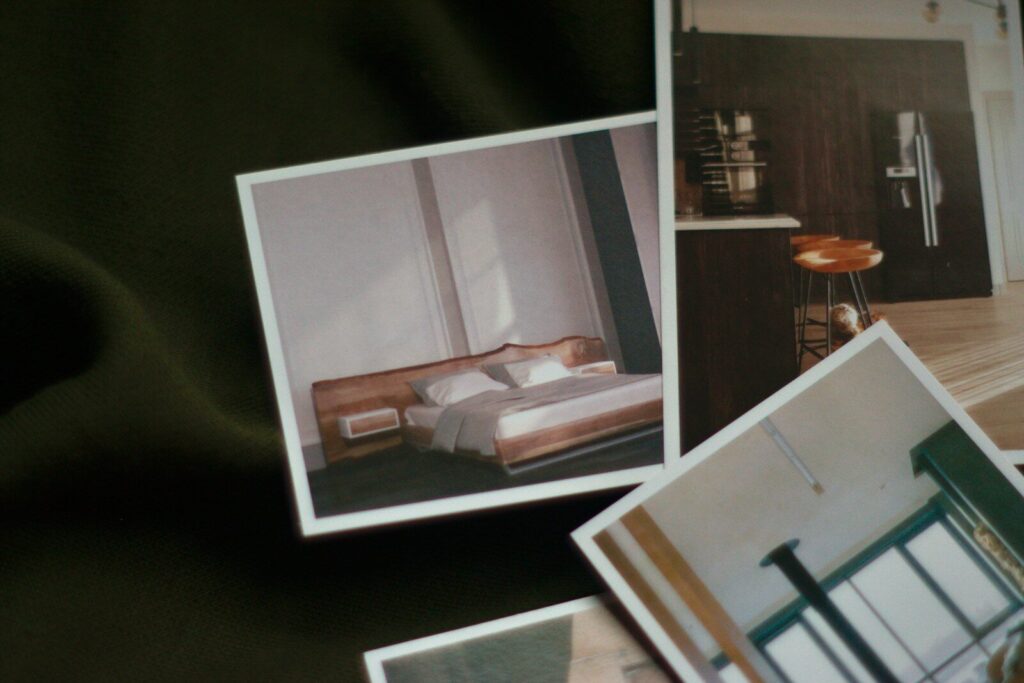 a bed room with a bed a chair and pictures